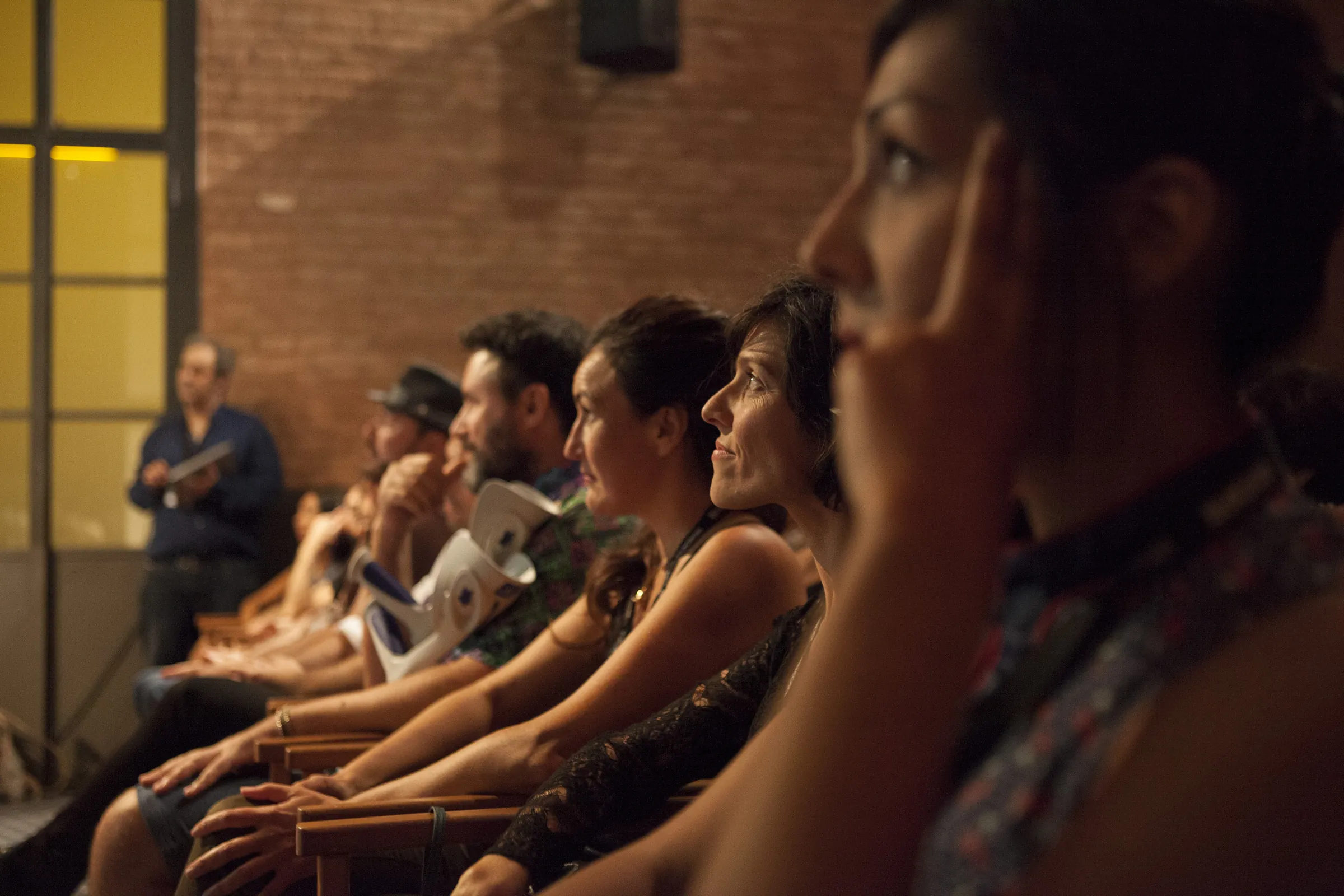 A row of people reading projected text during a session in Barcelona, 2016