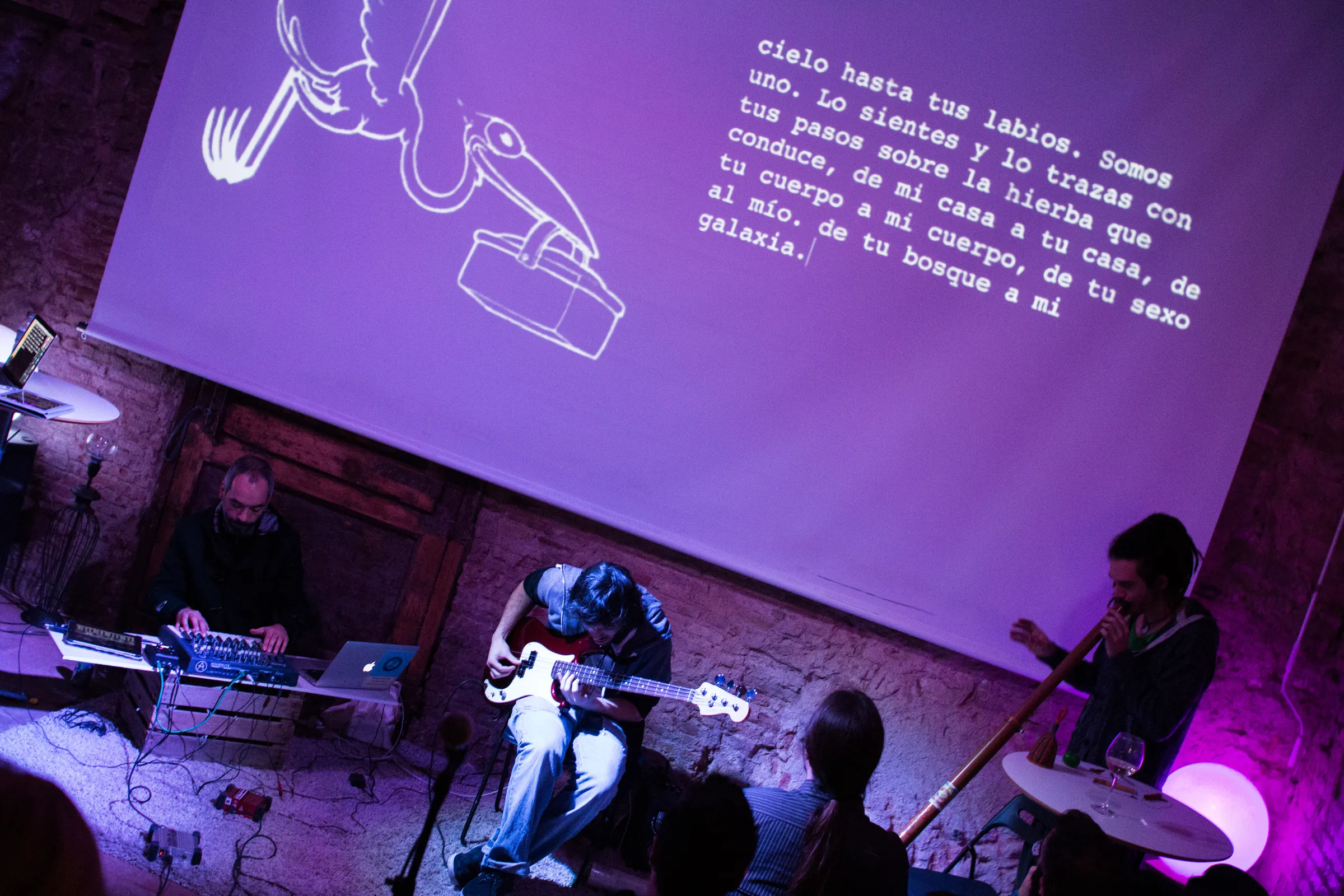 Projected text falling across the body of a performer during a Writing Concert